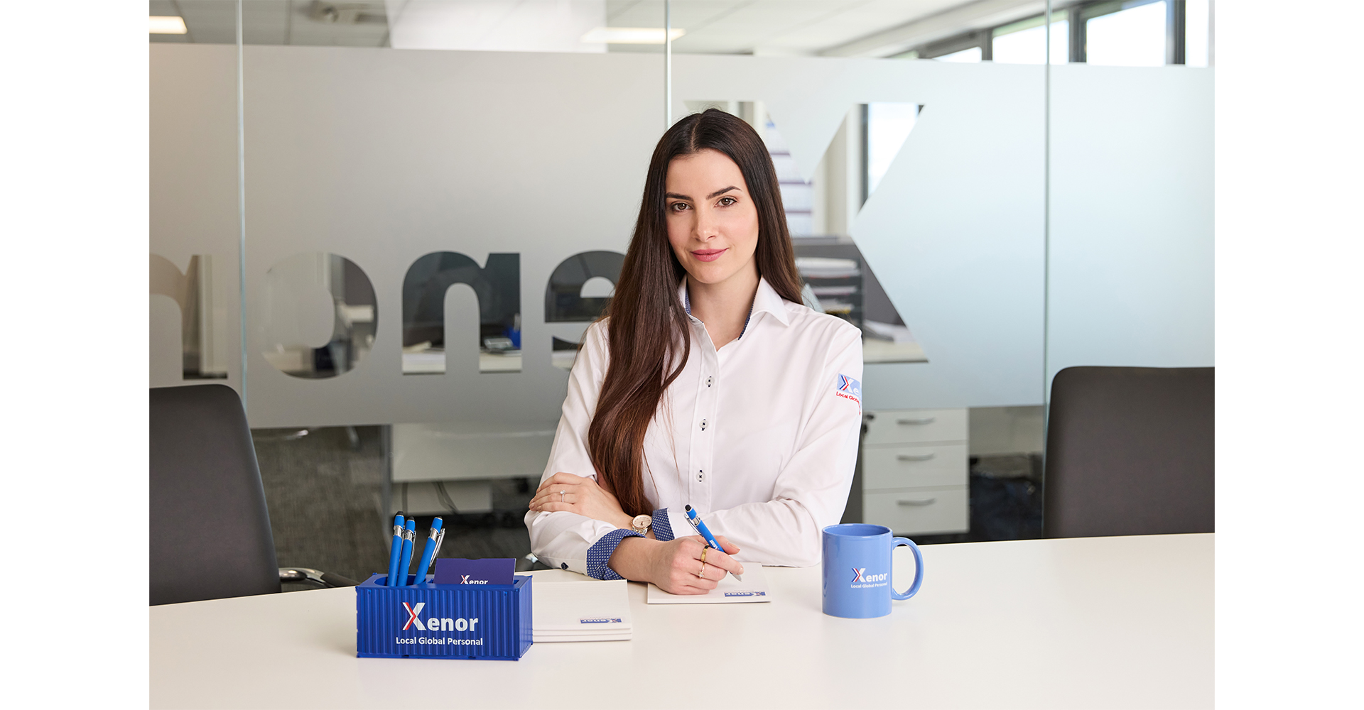 woman in office at desk posing for a corporate head shot in Norwich