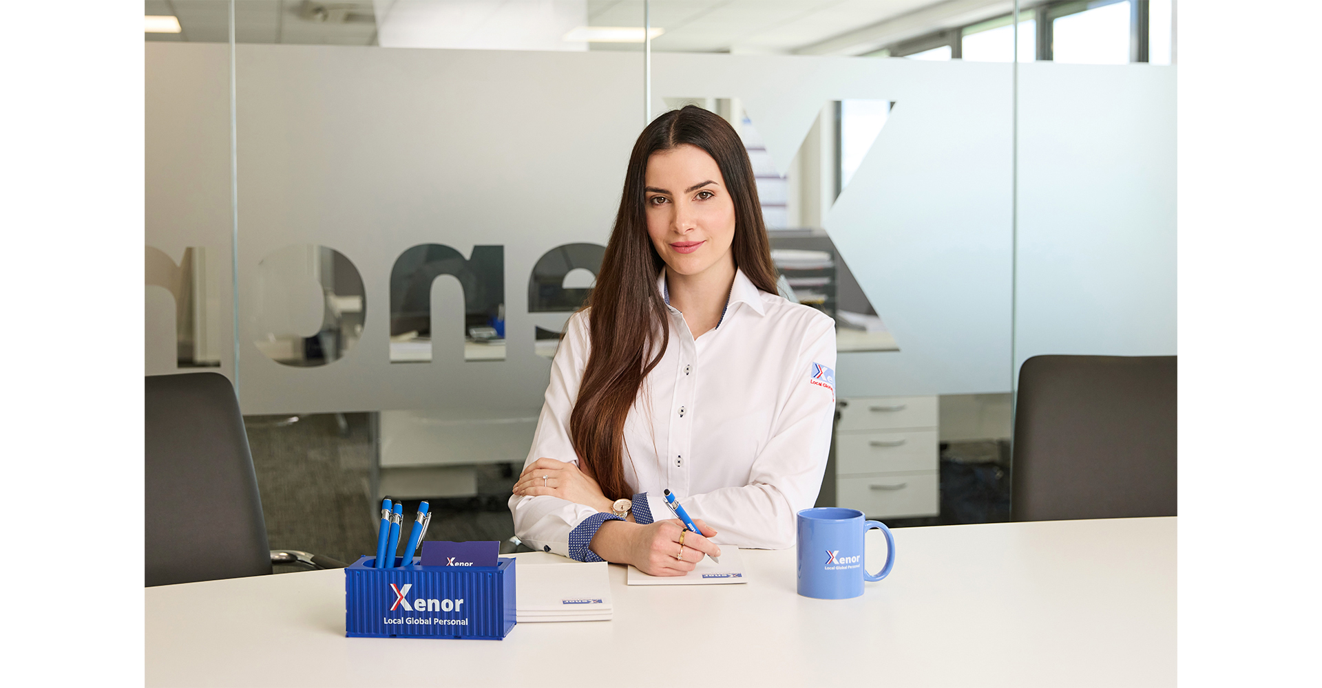 woman in office at desk posing for a corporate head shot in Norwich