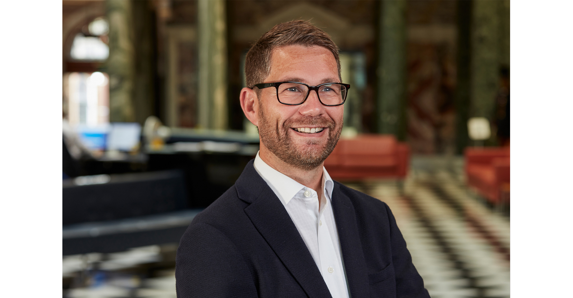 Man posing for a corporate head shot at Aviva head office marble hall Norwich