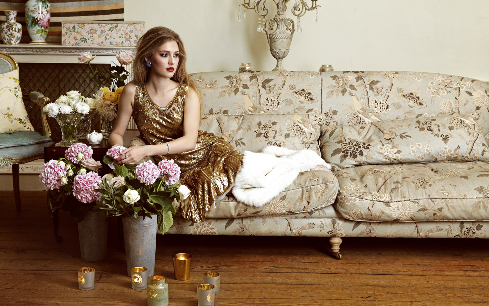 Model on a vintage couch looking away wearing antique jewellery on a photo shoot