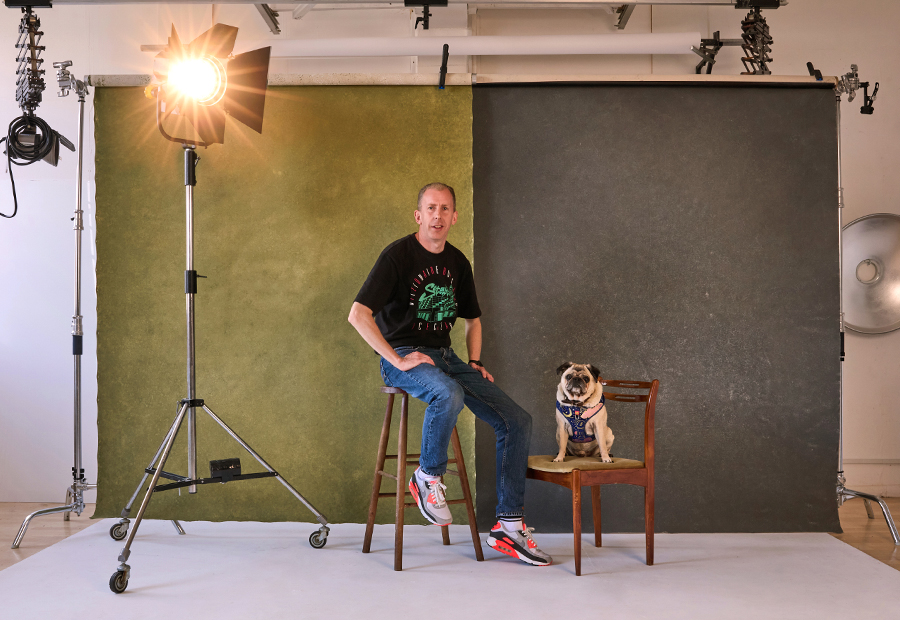 Nic Donovan Photographer with Melissa Abel make up artist in the studio in Norwich with photography equipment around them and the pug Poko